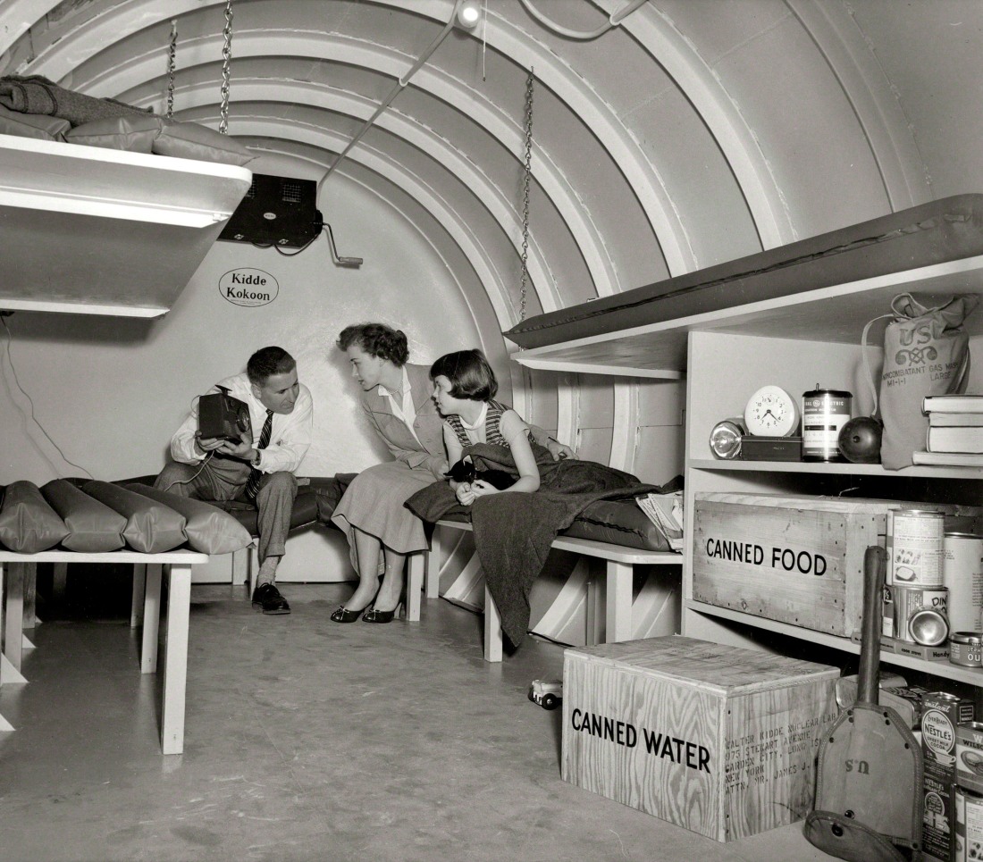 H-bomb hideaway. Family seated in a Kidde Kokoon, an underground fallout shelter United Press photo (1955)